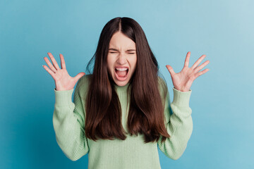 Portrait of crazy aggressive woman scream isolated on teal background