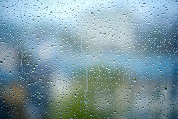 Many drops on the window, wet glass during heavy rain, as texture or background