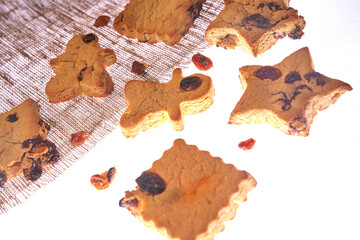 Cookies in different shapes, gluten-free, lactose-free, sugar-free healthy dessert with dark chocolate and raisins on an isolated white background