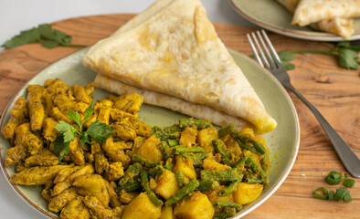 Indian-surinamese spicy food lunch and dinner roti chicken curry meal 