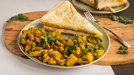 Indian-surinamese spicy food lunch and dinner roti chicken curry meal 
