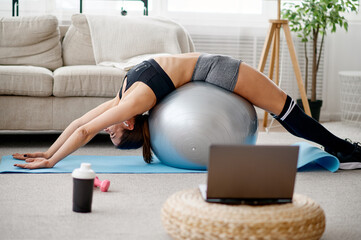 Woman with ball, online pilates training