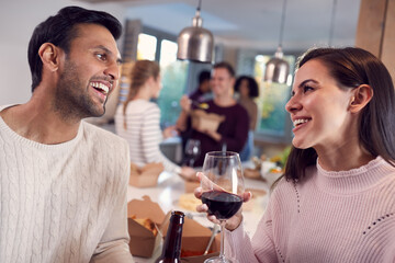 Group Of Multi Cultural Friends Enjoying Drinks Party With Takeaway Food At Home Together