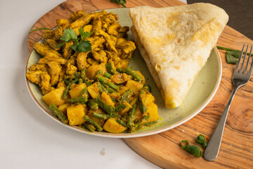 Indian-surinamese spicy food lunch and dinner roti chicken curry meal 