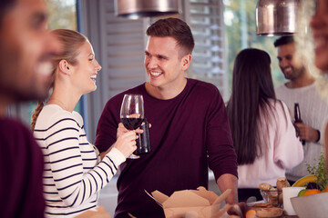 Group Of Multi Cultural Friends Enjoying Drinks Party At Home Together