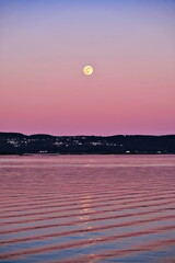 New moon in a low pink Norwegian sky