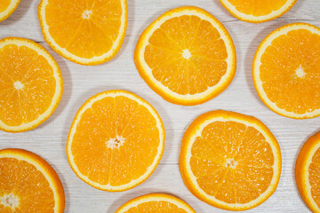 Yellow juicy orange on a background of bleached wood. Background on the theme of fruits, citrus fruits.