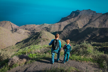 father and son travel in nature, family hiking