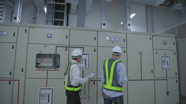 Business concept of 4k Resolution. Engineers are walking to inspect electrical equipment in the factory.