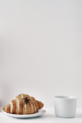 Mug and croissants on a white background. Eco-friendly and natural materials in the decor, dessert. Copy space, mock up