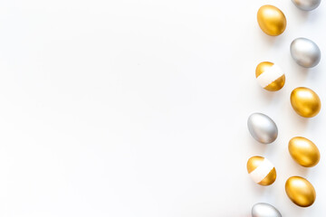 Happy Easter card with golden and silver eggs, top view