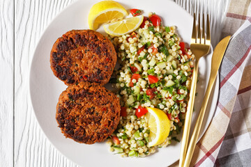 harissa lamb burger with couscous salad and lemon