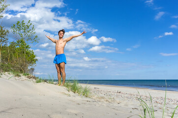 Charging on the beach. A young athlete on the beach. Gymnastics classes at sea.