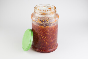 glass jar with raspberry jam isolated