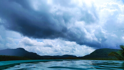 A scenic and unique view of cloudy mountains from an uphill swimming pool in Sri Lanka.
