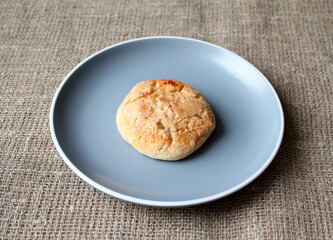ruddy cottage cheese pastries on a blue saucer. one cottage cheese cookie. cookies for coffee.