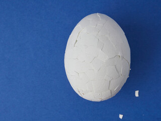 White eggs on a blue background. The concept of minimalism. Side view. A card with a copy of the place for the text.