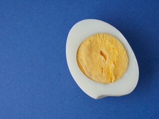 White eggs on a blue background. The concept of minimalism. Side view. A card with a copy of the place for the text.