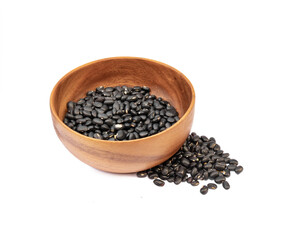 Black beans in wooden bowl on white background