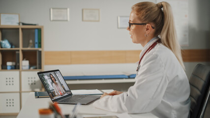 Doctor's Online Medical Consultation: Handsome Famale Physician is Making a Video Call with a Female Patient on Laptop Computer. Health Care Professional Giving Advice, Explaining Test Results.