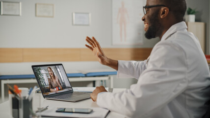 Doctor's Online Medical Consultation: Black Handsome Physician is Making a Video Call with a Female Patient on Laptop Computer. Health Care Professional Giving Advice, Explaining Test Results.