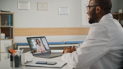 Doctor's Online Medical Consultation: Black Handsome Physician is Making a Video Call with a Female Patient on Laptop Computer. Health Care Professional Giving Advice, Explaining Test Results.