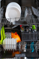 Dishwasher with clean dishes after cleaning with salt and detergent