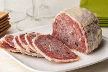 Saltufo sausage ball and slices on a dish close up as a snack or appetizer 