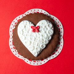 white heart, gingerbread biscuit on red background