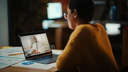 Beautiful Multiethnic Latina Manager is Making Video Call to His Doctor on Laptop in a Creative Office Environment. Man is Talking to His Medical Consultant Over a Live Camera, Asking about Health. - obrazy, fototapety, plakaty
