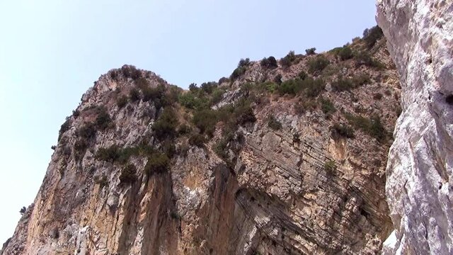 Summit of the calcareous “Natural arch” cliff that frames the namesake cove, Palinuro, Italy.