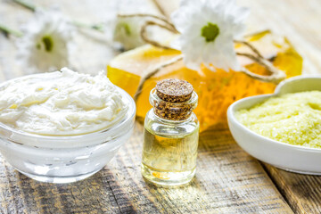 camomile essential oil in glass bottle in cosmetic set on table background