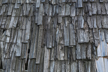 Texture of wooden unpainted roof tiles. Background of wooden tiles.