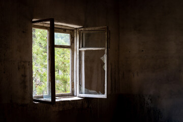 Dirty old open window with broken glass in abandoned house in ghost town Pripyat, Chernobyl Exclusion Zone, Ukraine