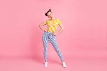 Fototapeta na wymiar Full size photo of optimistic brunette lady stand blow kiss wear yellow t-shirt pants sneakers isolated on pink color background
