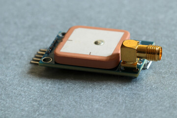 GPS module with ceramic antenna for receiving signals from satellites. Selective focus on SMA...