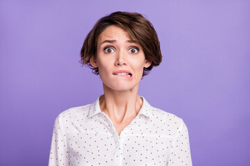 Portrait of attractive worried unsure uncertain brown-haired girl manager biting lip isolated over bright violet purple color background - obrazy, fototapety, plakaty