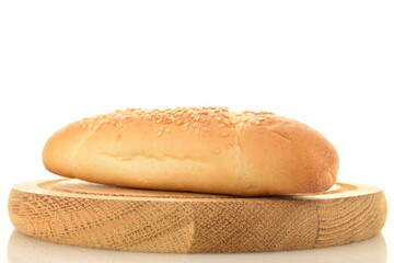 One delicious fragrant bagel on a round wooden tray, close-up, isolated on white.