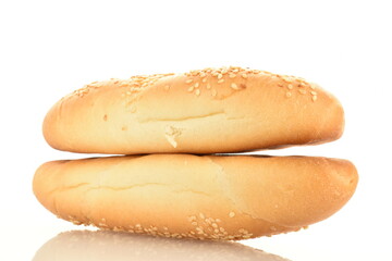 Two delicious fragrant bagels with a jute napkin, close-up, isolated on white.