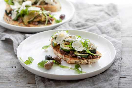 Vegetarian bruschette with olives and courgettes