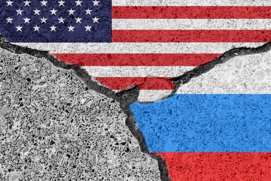 Economic and political conflict and confrontation between Russia and USA. Conceptual image of countries flags with a broken crack between them. Copy space for text or design.