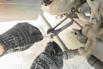 Auto mechanic disassembly car stabilizer control link, Car maintenance service.