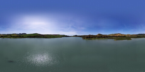 360 degree aerial photo of Villarosa lake in Sicily. Immersed in a luxuriant nature and destination of numerous migratory birds. Relax around the lake. Nature in Sicily.