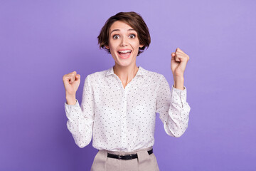 Photo of impressed funny person open mouth shout yes fists up celebrate isolated on violet color background