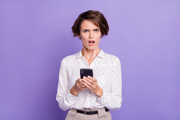 Photo of pretty unsatisfied lady open mouth staring camera bad fake news isolated on violet color...