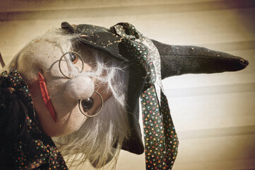 Witch doll on vintage background