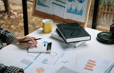 Close up view of bookkeeper or financial inspector hands making report, calculating or checking...