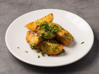 potato slices with herbs on a white plate