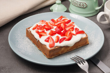 viennese waffle with strawberries and sour cream sauce