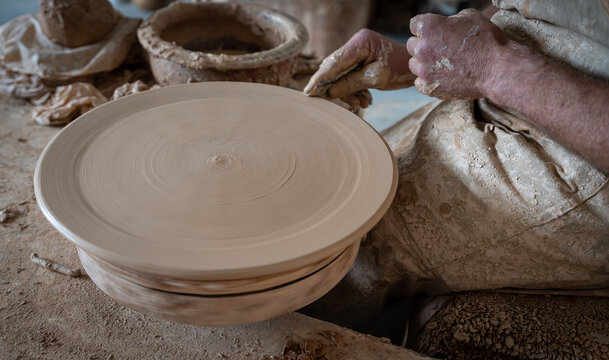 Potter hand working on pottery, closeup view
